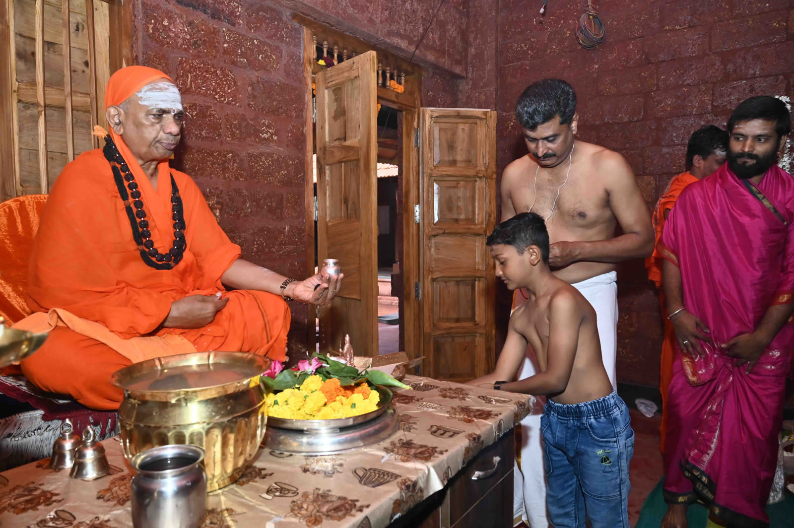 Sankalpa and teertha blessings inside the Kerala-style block